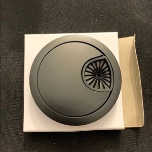 Black desk grommet for wire organizer.